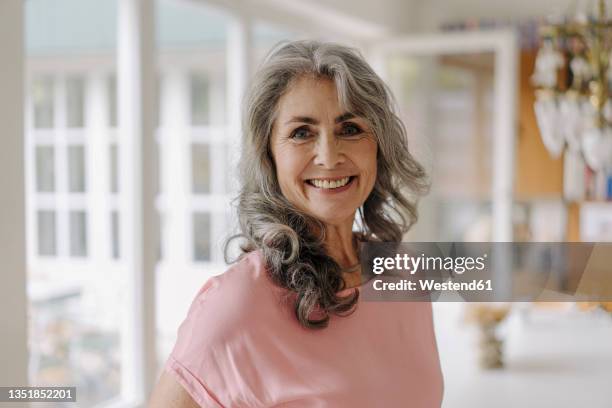 portrait of smiling mature woman at home - grey hair woman stock pictures, royalty-free photos & images