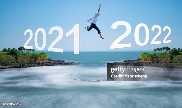 people jump from year 2021 to year 2022 - the end words stock pictures, royalty-free photos & images