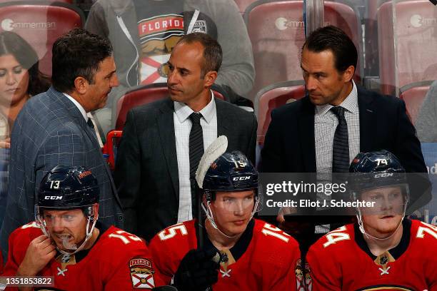 Florida Panthers Interim Head Coach Andrew Brunette chats with Assistant Coaches Derek MacKenzie and Tuomo Ruutu during a break in the action against...