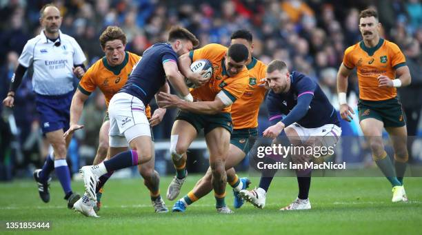 Izaia Perese of Australia is tackled by Ali Price and Finn Russell of Scotland during the Autumn Nations Series match between Scotland and Australia...