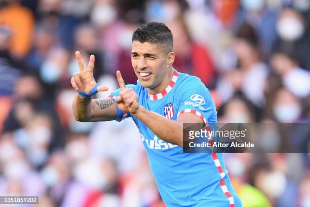 Luis Suarez of Atletico Madrid celebrates after scoring their side's first goal during the La Liga Santander match between Valencia CF and Club...