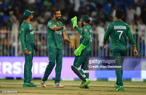 Imad Wasim of Pakistan celebrates after running out Matthew Cross of Scotland with team mate Mohammad Rizwan during the ICC Men's T20 World Cup match...