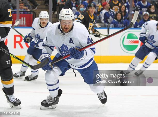 Morgan Rielly of the Toronto Maple Leafs chases after a puck against the Boston Bruins during an NHL game at Scotiabank Arena on November 6, 2021 in...