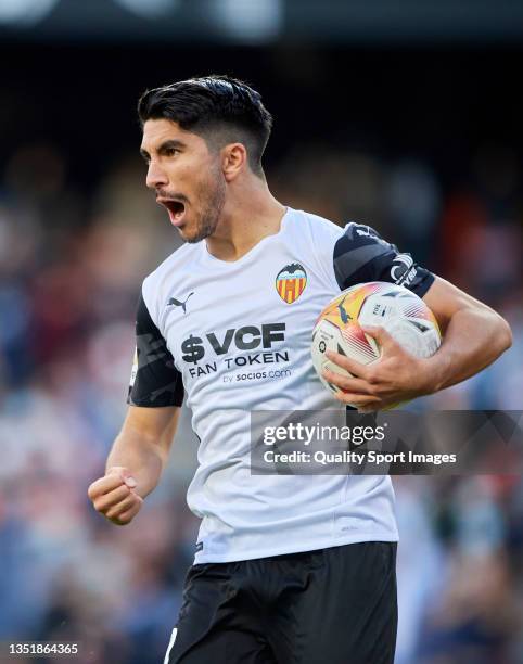 Carlos Soler of Valencia CF celebrates after their side's first goal, an own goal scored by Stefan Savic during the LaLiga Santander match between...