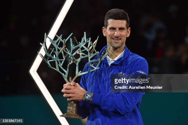 Novak Djokovic of Serbia poses with the trophy after winning the Men's Single's final match against Daniil Medvedev of Russia on Day Seven of the...