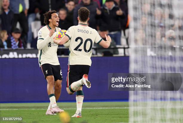 Trent Alexander-Arnold of Liverpool celebrates with Diogo Jota after scoring their side's first goal during the Premier League match between West Ham...