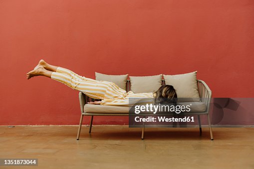 Tired young woman sleeping on sofa Tired young woman sleeping on sofa