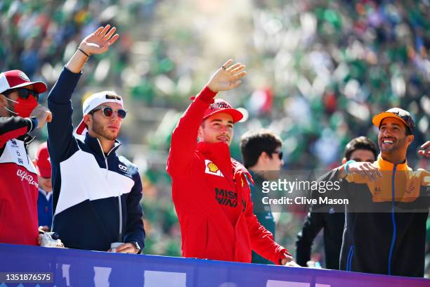 Pierre Gasly of France and Scuderia AlphaTauri and Charles Leclerc of Monaco and Ferrari wave to the crowd on the drivers parade before the F1 Grand...