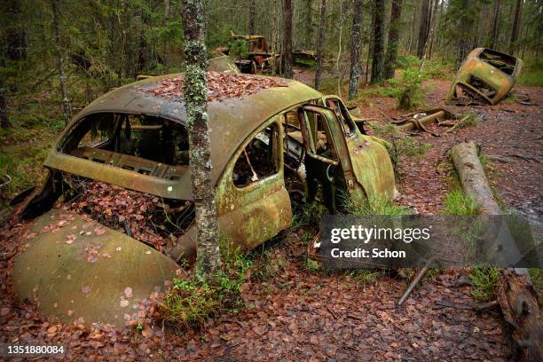 scrap trucks on the abandoned junkyard kyrkö mosse outside ryd in southern sweden - abandoned car - fotografias e filmes do acervo