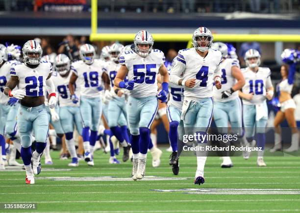 Dak Prescott, Leighton Vander Esch, and Ezekiel Elliott of the Dallas Cowboys lead the team onto the field before the game against the Denver Broncos...