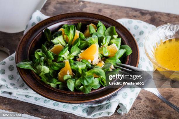 plate of corn salad with pieces of orange - mache stock pictures, royalty-free photos & images