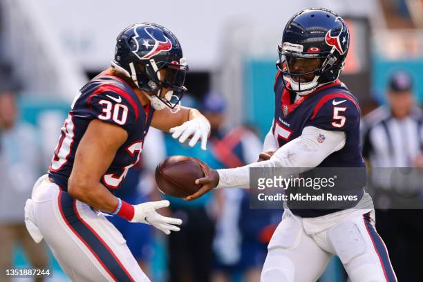 Quarterback Tyrod Taylor of the Houston Texans hands the ball off to Phillip Lindsay in the first quarter against the Miami Dolphins at Hard Rock...