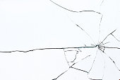 Bullet hole in broken glass on a white background. Shards of glass
