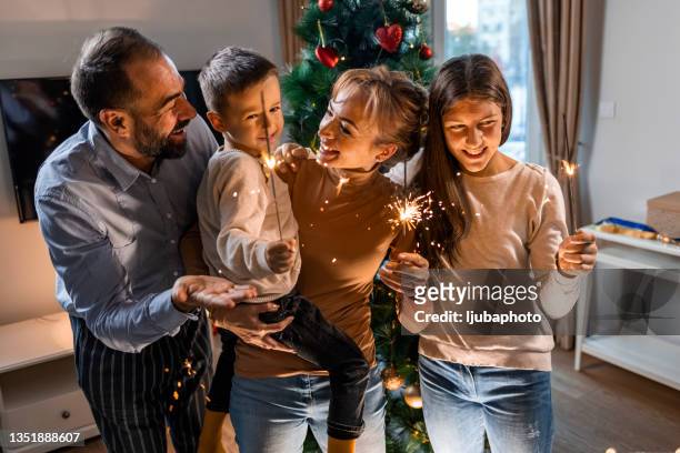 family celebrating new year together - new year stock pictures, royalty-free photos & images