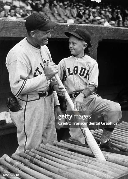 Hall of Fame player-manager for the St. Louis Browns, Rogers Hornsby, poses for a photo with his son before a ball game in St. Louis, Missouri in...