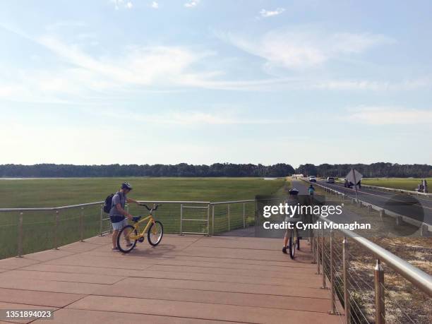 family biking to assateague island - chincoteague island stock pictures, royalty-free photos & images