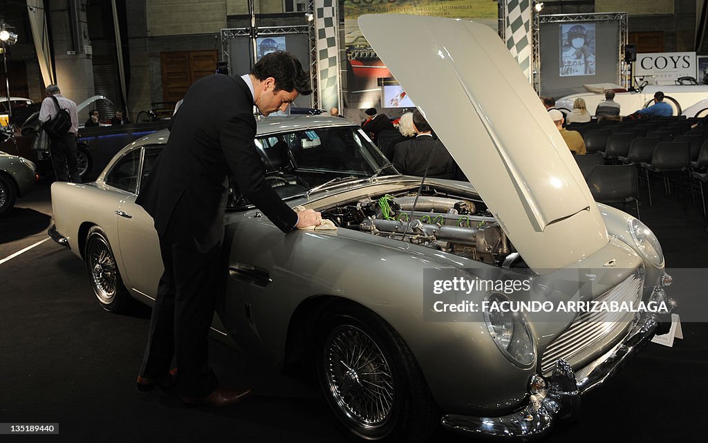 A member of staff polishes an Aston Mart