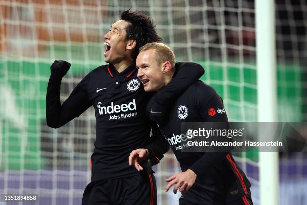 Sebastian Rode of Eintracht Frankfurt celebrates after scoring their team's first goal with teammate Daichi Kamada during the Bundesliga match...