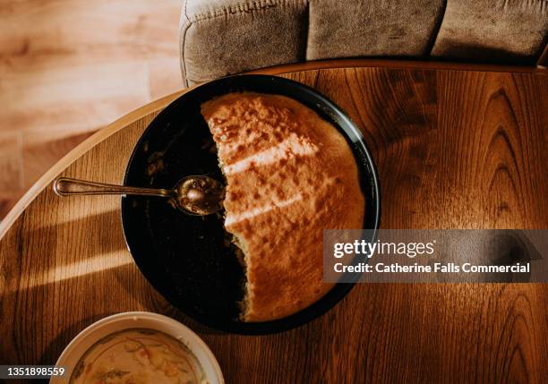 top down image of a half eaten apple sponge pudding / cake in a metal cake tin. - cake slices stock pictures, royalty-free photos & images