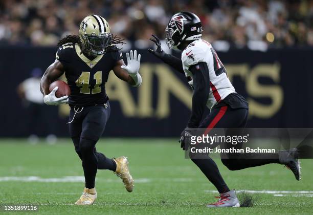 Alvin Kamara of the New Orleans Saints runs the ball while defended by Deion Jones of the Atlanta Falcons during the third quarter at Caesars...