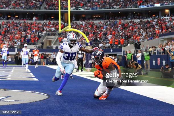 Courtland Sutton of the Denver Broncos catches the ball in front of Anthony Brown of the Dallas Cowboys for a touchdown during the fourth quarter at...
