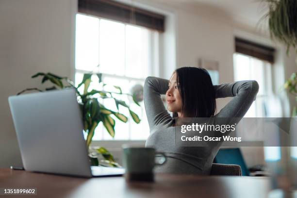 young woman taking a break while working at home - mental wellbeing stock-fotos und bilder