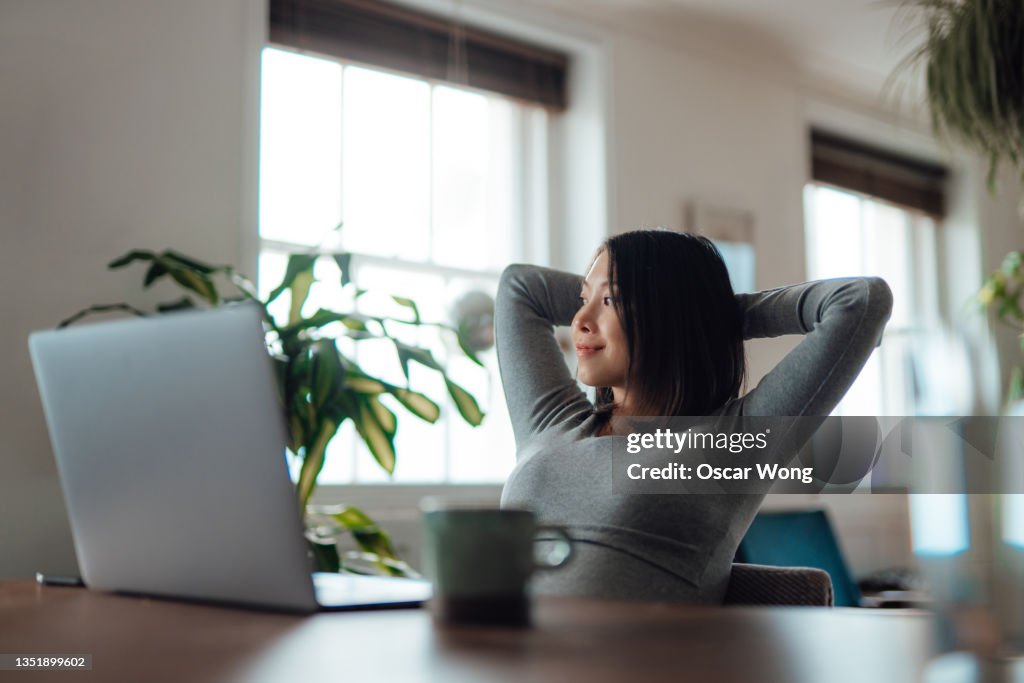 Young woman taking a break while working at home