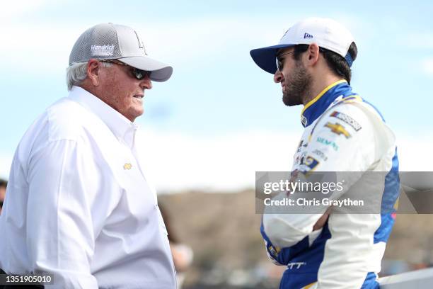 Chase Elliott, driver of the NAPA Auto Parts Chevrolet, speaks with NASCAR Hall of Famer and team owner Rick Hendrick on the grid prior to the NASCAR...