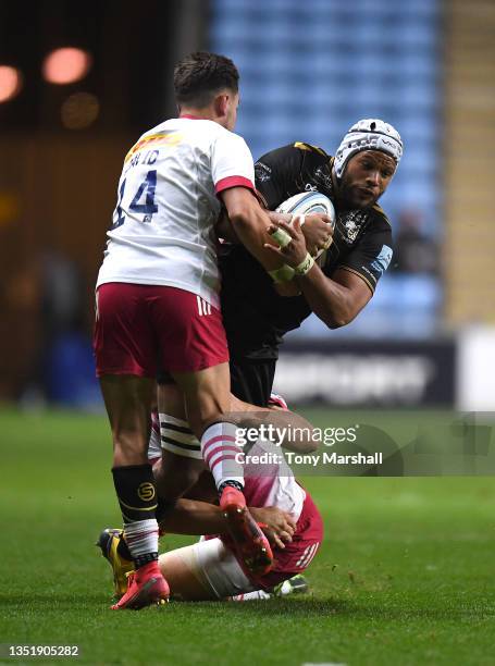 Nizaam Car of Wasps is tackled by Nick David and Andre Esterhuizen of Harlequins during the Gallagher Premiership Rugby match between Wasps and...