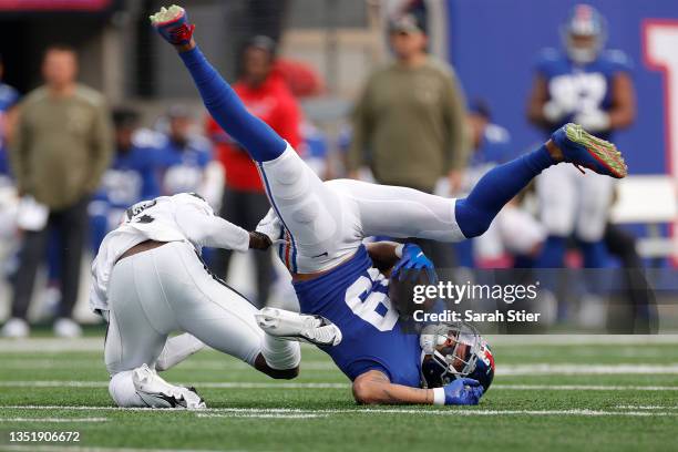 Kenny Golladay of the New York Giants makes a catch while defended by Brandon Facyson of the Las Vegas Raiders during the third quarter at MetLife...