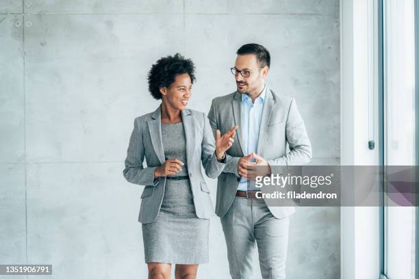 two cheerful business people - businesswear stock pictures, royalty-free photos & images