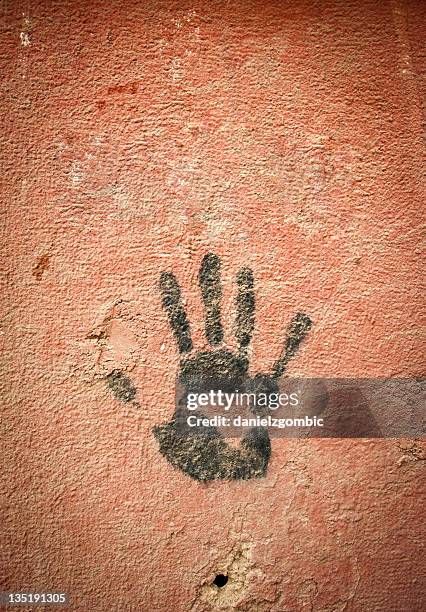 hand print on the wall with a bullet hole. - thumb war stock pictures, royalty-free photos & images