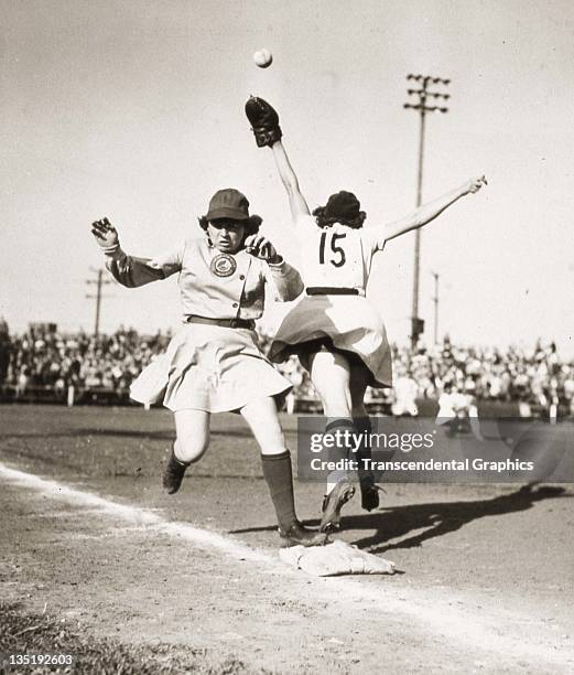 Marie Mahoney of the Racine Belles of the All-American Girls Baseball League is safe at first in a game against the South Bend Blue Sox at Racine,...