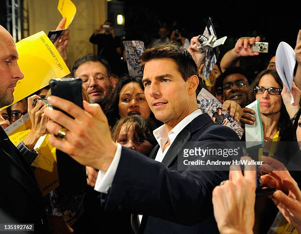 Actor Tom Cruise poses with fans as he attends the "Mission: Impossible - Ghost Protocol" Premiere during day one of the 8th Annual Dubai...