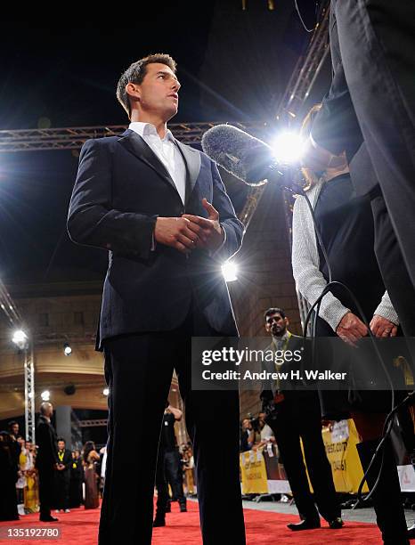 Actor Tom Cruise speaks to the media as he attends the "Mission: Impossible - Ghost Protocol" Premiere during day one of the 8th Annual Dubai...