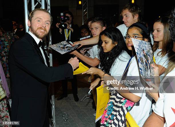 Actor Simon Pegg signs autographs for fans as he attends the "Mission: Impossible - Ghost Protocol" Premiere during day one of the 8th Annual Dubai...