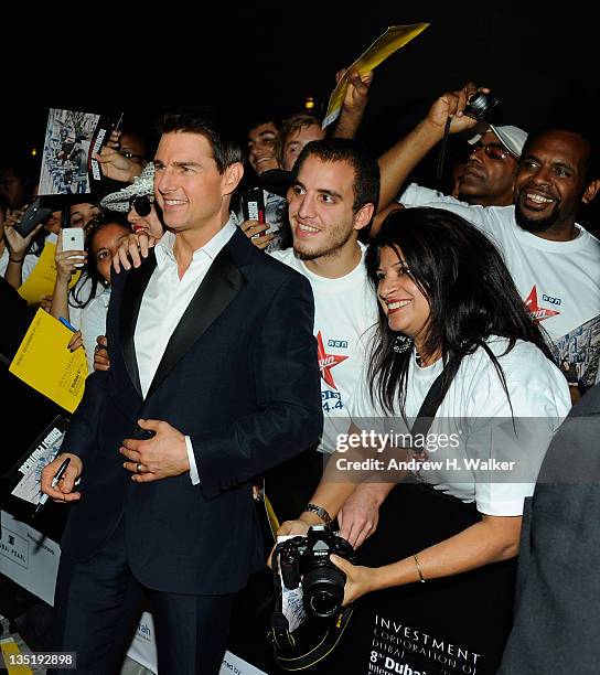 Actor Tom Cruise poses with fans as he attends the "Mission: Impossible - Ghost Protocol" Premiere during day one of the 8th Annual Dubai...