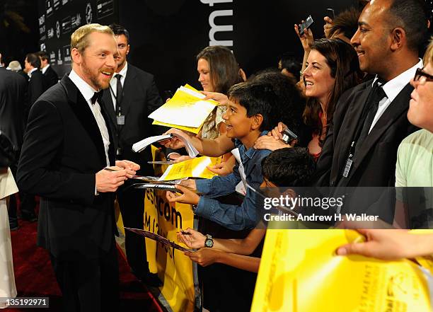 Actor Simon Pegg signs autographs as he attends the "Mission: Impossible - Ghost Protocol" Premiere during day one of the 8th Annual Dubai...