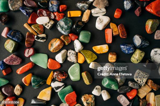 background made of many different multi colored minerals and semi precious stones. macro photography in flat lay style - jasper mineral stock pictures, royalty-free photos & images