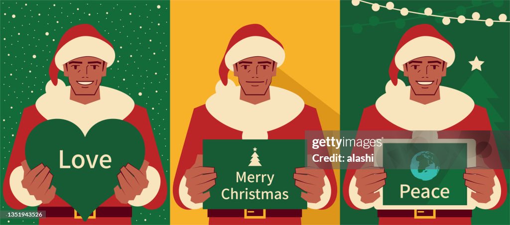Happy handsome mature men dressed in a Santa Claus suit holding a Christmas greeting card and heart shape sign and digital tablet