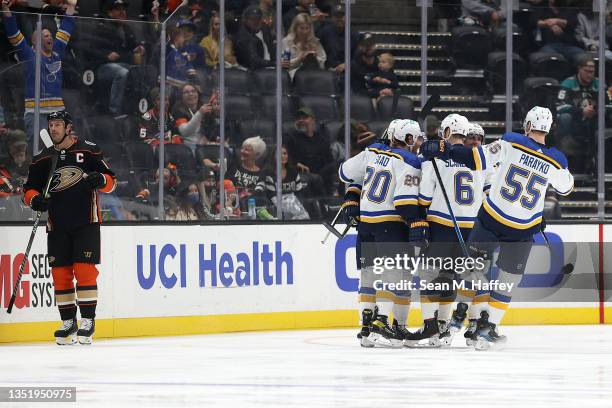 Ryan Getzlaf of the Anaheim Ducks looks on as Colton Parayko and Marco Scandella congratuate Brandon Saad of the St. Louis Blues after his goal...