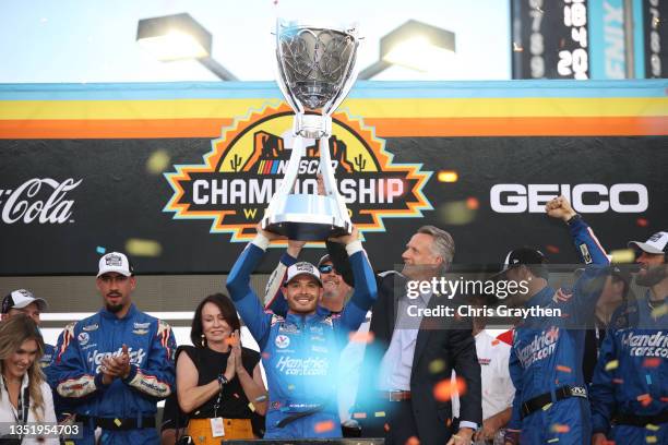 Kyle Larson, driver of the HendrickCars.com Chevrolet, is presented the Bill France 2021 NASCAR Cup Series Championship trophy by NASCAR President...