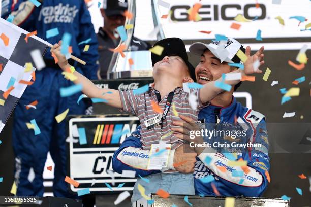 Kyle Larson, driver of the HendrickCars.com Chevrolet, celebrates with his son, Owen in victory lane after winning the NASCAR Cup Series Championship...