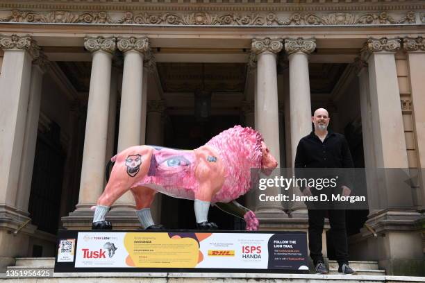 Artist David Griggs is seen with his art installation titled "Civilian Warrior" after being unveiled on the steps of Town Hall on November 08, 2021...