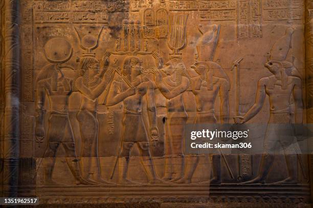 sand stone carving of egyptian god and goddess at temple of kom ombo locate at north aswan city egypt - ancient egyptian culture stock pictures, royalty-free photos & images