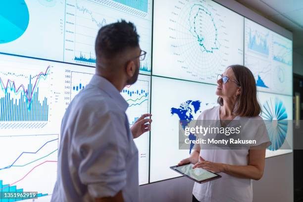 uk, york, business people discussing charts on interactive screens - business strategy - fotografias e filmes do acervo