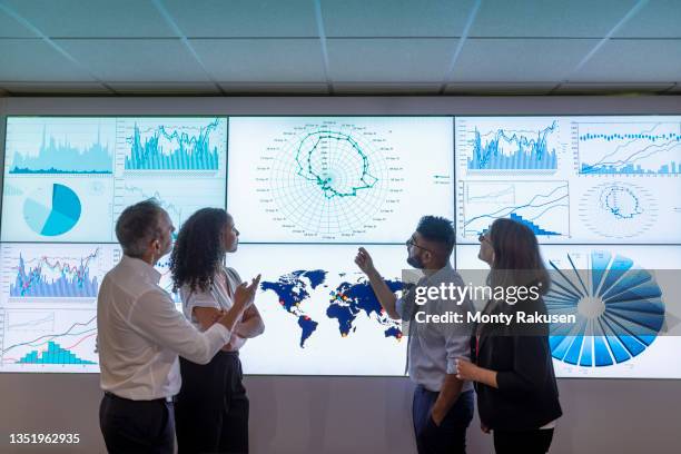 uk, york, business people discussing charts on interactive screens - international day four stock pictures, royalty-free photos & images