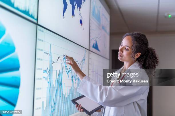 uk, york, female researcher inspecting charts on interactive screens - berührungsbildschirm stock-fotos und bilder