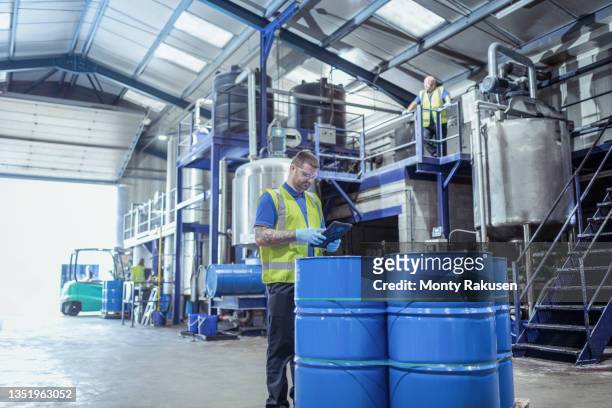 uk, manchester, workers in oil blending plant - barrel stock pictures, royalty-free photos & images