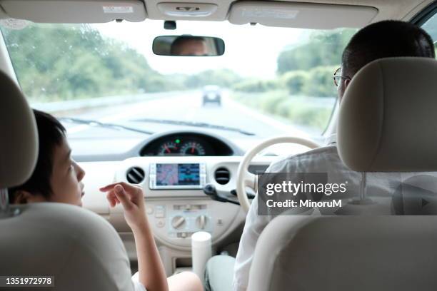 father and son riding a car - comfortable car stock pictures, royalty-free photos & images